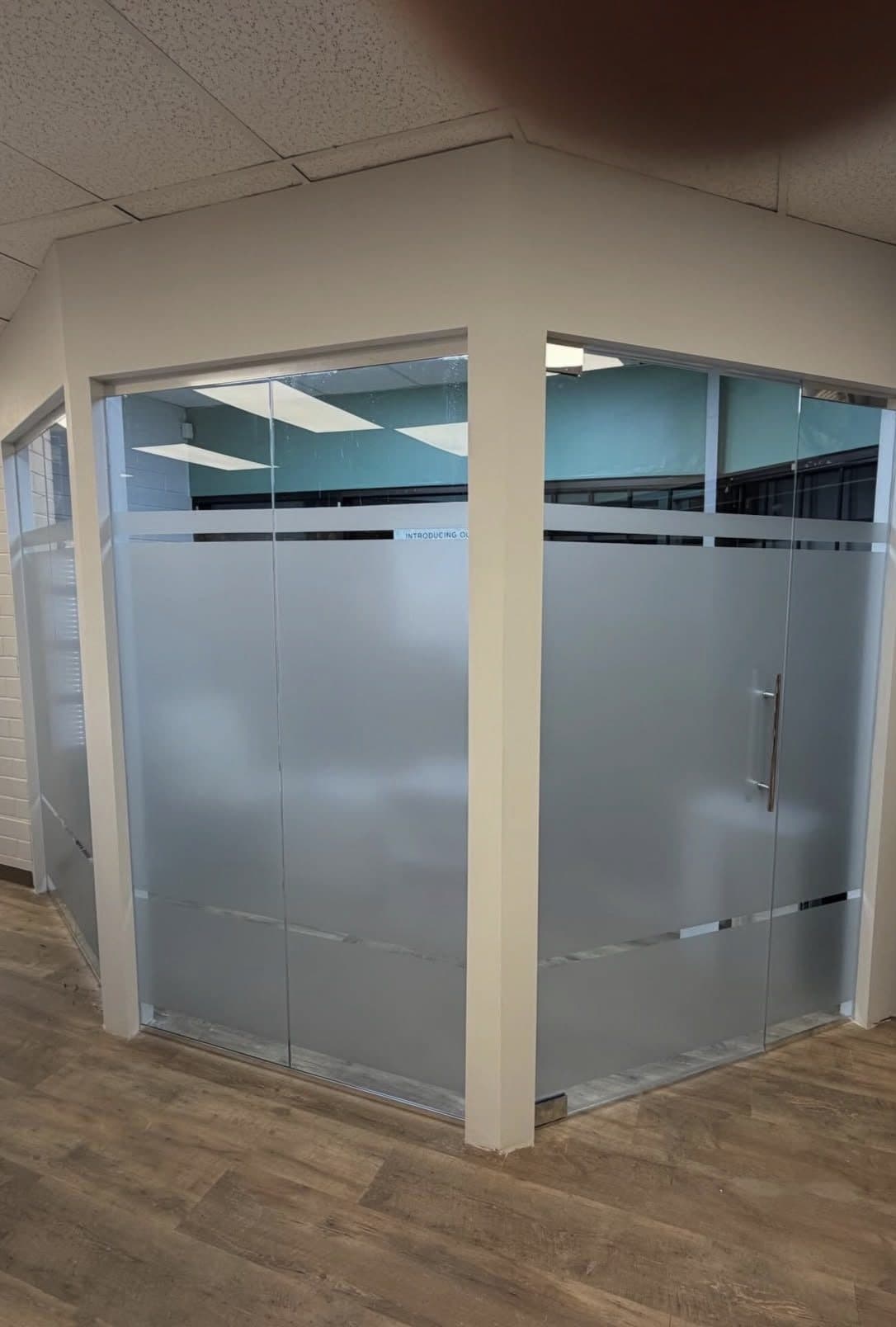 Frosted glass partition walls enclosing an office corner