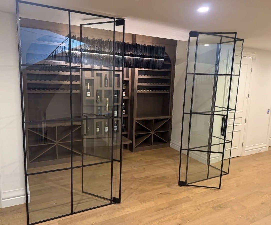 Black-framed glass wine room with one door standing open
